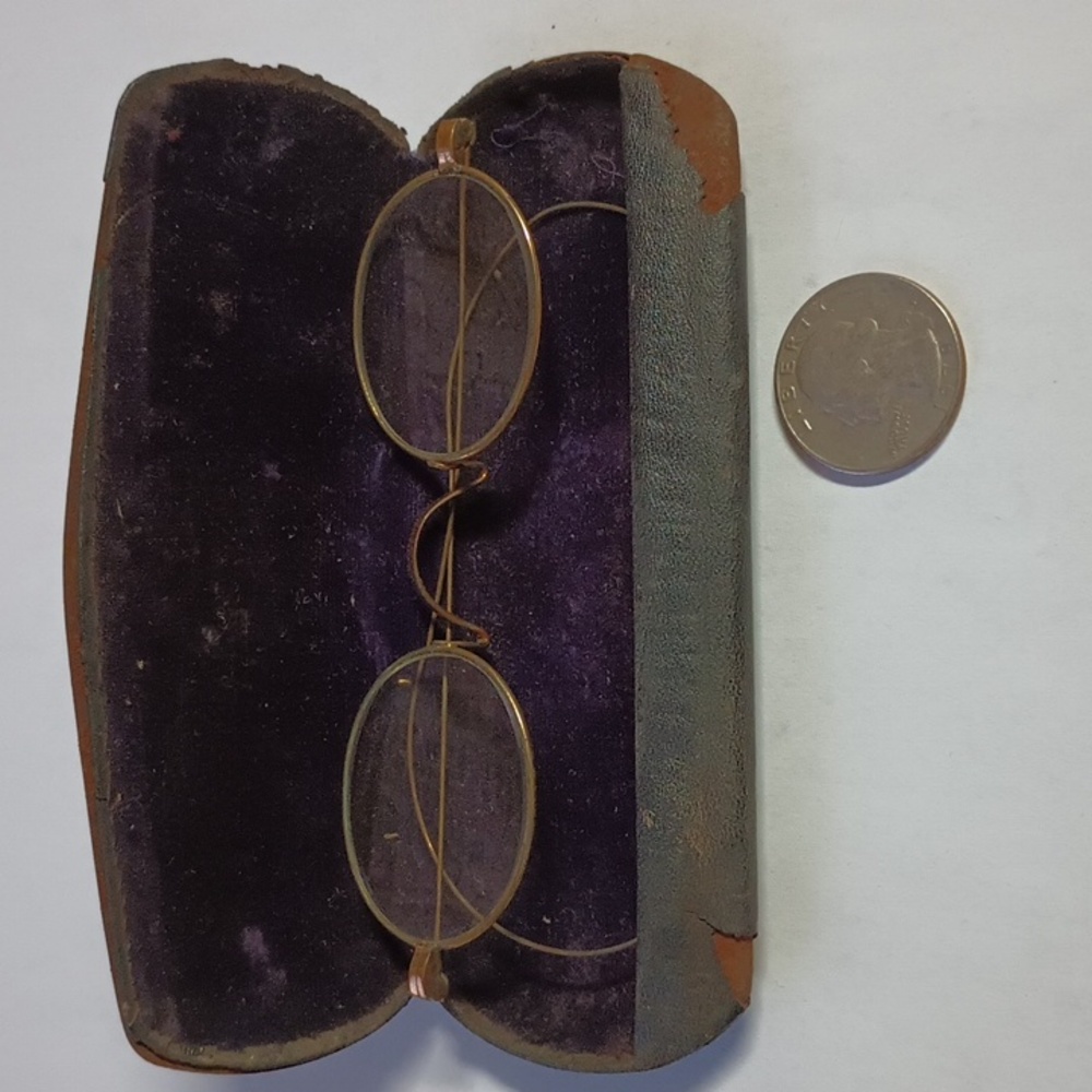 Vintage eyeglasses with purple velvet lined case
